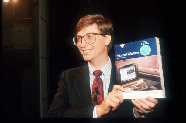 Bill Gates holding his first Windows program.  (Bio.com (Bio.com))