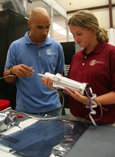 NASA Senior Mechanical Engineer, Kobie Boykins, shows Student Argonaut Janelle Wilson a part of the Mars rover.  Wilson was at NASA Jet Propulsion Laboratory, where the Mars rovers Spirit and Opportunity were designed, as part of the JASON Expedition: Mysteries of Earth and Mars.<p>