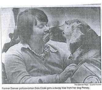 Dale receiving a kiss from her dog. (<i>Denver Post</i>)