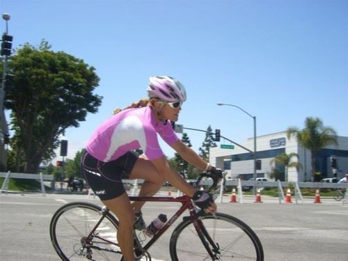 This is a picture of Coach Bee riding her bike. (This picture was taken at a race on Memorial Day.)