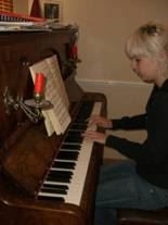Rhea, practicing on Ol' Joanna (the Piano)