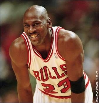 Michael Jordan is wearing his Bulls jersey. (http://cm1.theinsider.com/media/0/110/33/jordan.0.0.0x0.337x350.jpeg.The photographer was Jonathan Darie.)
