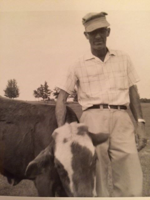 This is my hero with a cow on his ranch. (My great grandmother took this picture. (My great grandmother.))