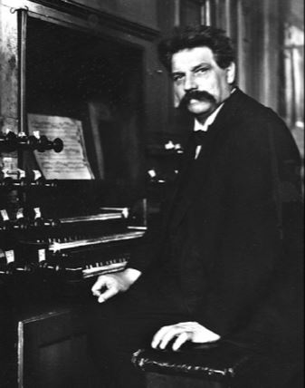 Albert Schweitzer sitting front of organ (www.ahlborn-galanti.com ())