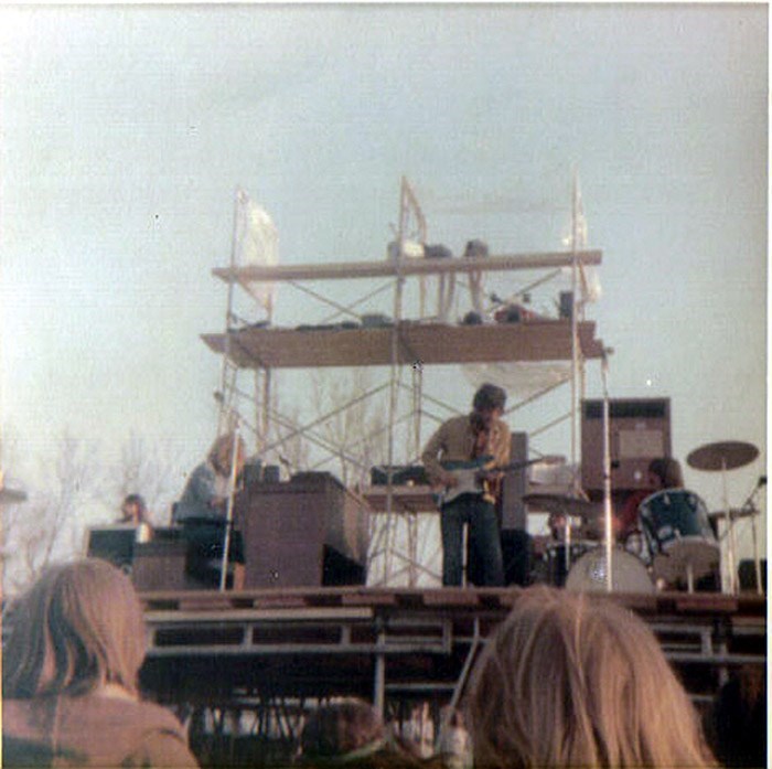 Wayne McKibbin playing guitar with his band 