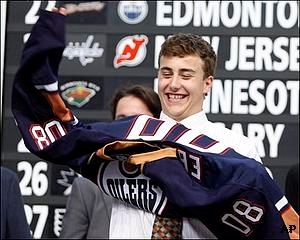 Jordan Eberle putting on an Edmonton Oilers jersey (http://oilers.nhl.com/club/news.htm?id=430639	 (unknown))