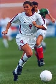 Mia Hamm dribbling the ball to Score a goal. (http://espnmediazone.com/us/press-releases/2012/06 (http://espnmediazone.com/us/press-releases/2012/06))