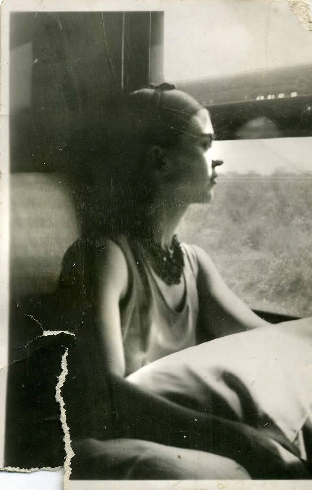 Frida pictured looking out a window (http://www.museofridakahlo.org.mx/esp/1/frida-kahl ())