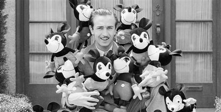Walt is standing with Mickey Mouse, his creation. (https://d23.com/about-walt-disney/ ())