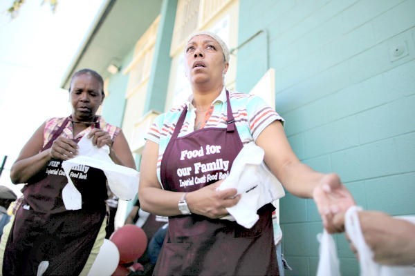 Volunteers hand out groceries at the opening of a food bank to serve the 1,454 residents at the Imperial Courts public housing project in Los Angeles in 2011.  Lucy Nicholson/Reuters/File