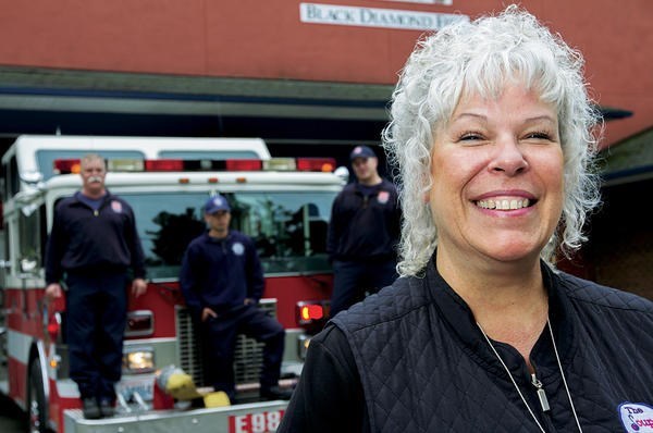 Ginger Passarelli, Soup Ladies president and volunteer, stands in front of the Black Diamond Fire Station 98 in Black Diamond, Wash.  <P>Melanie Conner/Special to The Christian Science Monitor