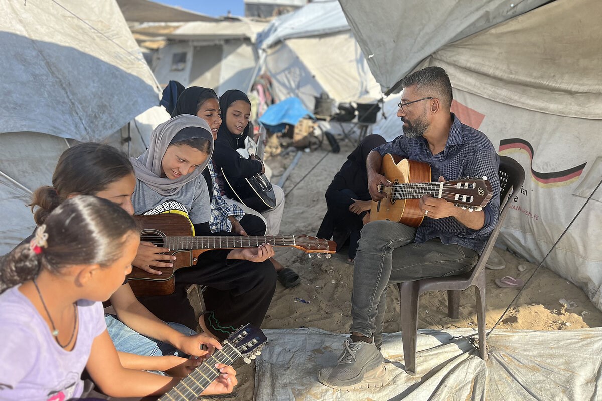 Picture of In Gaza, a music teacher sings above the din of war