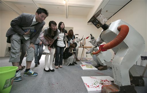 Visitors look at robots invented by Wu Yulu, a 48-year-old farmer from Beijing, at Shanghai's Rockbund Museum, Tuesday, May 11, 2010, in Shanghai, China. The museum opened the exhibit on May 4 alongside the Shanghai World Expo. (AP Photo)