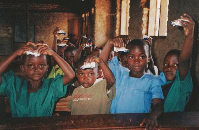 Ugandan children learned about the ambulance with miniature Matchbox ambulances.<br>Photo from www.scoutbanana.catholicweb.com