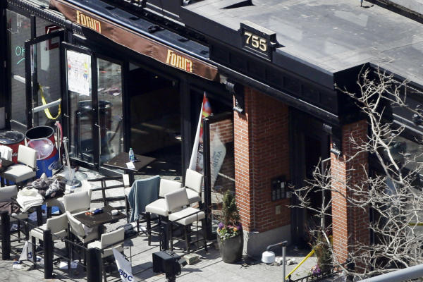 An April 16 photo shows the front of the Forum restaurant, the scene of one of two bombings near the finish line of the 2013 Boston Marathon, the next day. Patrons praised restaurant employees for quick action in keeping them calm and helping them evacuate using a back stairway. One patron saw staffers bring towels and help tend the wounded.  <P>Elise Amendola/AP/File