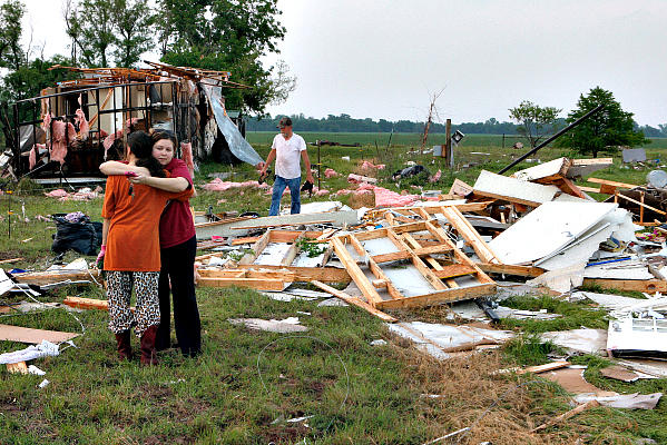 Leah Hill (lef), of Shawnee, Okla., is hugged by friend Sidney Sizemore as they look through Hill's scattered belongings from her home, which was destroyed by a tornado west of Shawnee May 19. A huge tornado struck near Oklahoma City May 19, part of a massive storm front that hammered the central United States. <P> Bill Waugh/Reuters