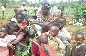 Prof. Wangari Maathai joins children in tree planting in Karura forest, Nairobi<br>Credit: Green Belt Movement 