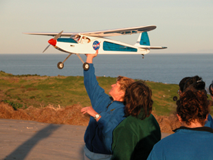 Teacher Argonaut Sue Sewell practices launching one of NASA's UAVs.
