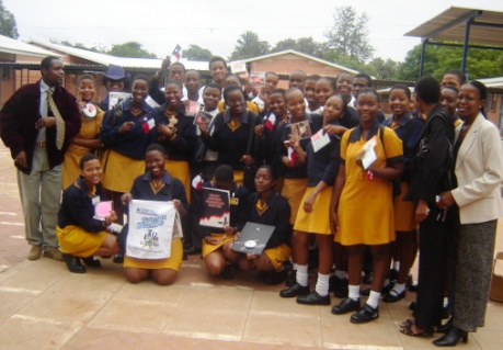 Tommie and his students working on the malaria project in Gaborone, Botswana.  They are displaying souvenirs from Texas which were sent by a school through the intercultural project.