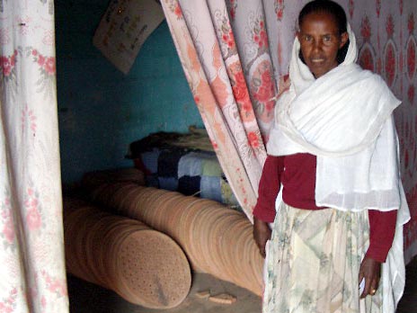 Beleza's organizer poses with the ceramic firegrates being stored in her living room