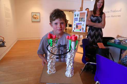 Young engineer at the MY HERO booth with his dual electricity generators