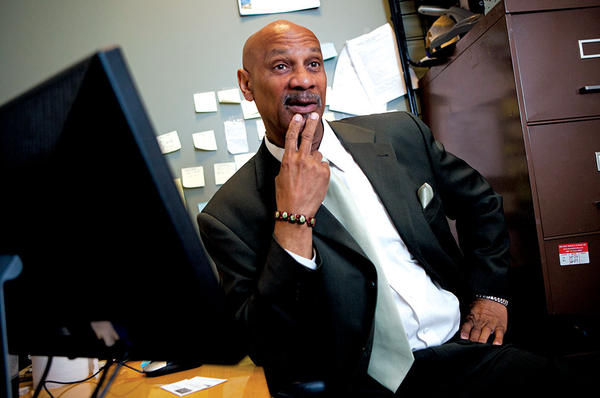 Paralegal Johnny Outlaw sits in his office at Kennedy-King College in Chicago where he heads Teamwork Englewood’s reentry programs for ex-convicts. <P>Melanie Stetson Freeman/Staff