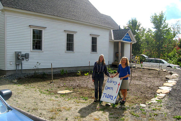 Cindy Dunham (left) and new library director Sheila Polson were among the local volunteers who helped to build the first community library in Lincolnville, Maine. Landscaping for the once-abandoned property is being added this fall. <P>David Hugh Smith
