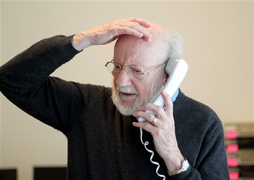 Scientist William C. Campbell talks on the phone at his home in North Andover, Mass., Monday, Oct. 5, 2015. Campbell is one of three scientists from the U.S., Japan and China who won the Nobel Prize in medicine on Monday for discovering drugs to fight malaria and other tropical diseases that affect hundreds of millions of people every year. (AP Photo/Mary Schwalm)