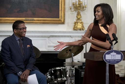 First lady Michelle Obama acknowledges musician Herbie Hancock as she speaks to high school students from across the Washington D.C. area in State Dining Room of the White House in Washington, Friday, April 29, 2016, as part of the International Jazz Day celebration. (AP Photo/Carolyn Kaster)