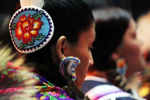 A dancer with beaded hair and head pieces participates in the 33rd annual Gathering of Nations in Albuquerque, N.M., on Friday, April 29, 2016. (AP Photo/Susan Montoya Bryan)