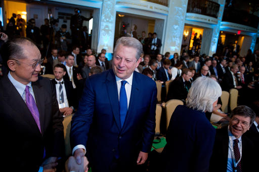 Former Vice President Al Gore, center, accompanied by World Bank President Jim Yong Kim, left, arrives before a speech by United Nations Secretary General Ban Ki-moon at the Climate Action 2016 Summit at the Mayflower Hotel in Washington, Thursday, May 5, 2016. (AP Photo/Andrew Harnik)