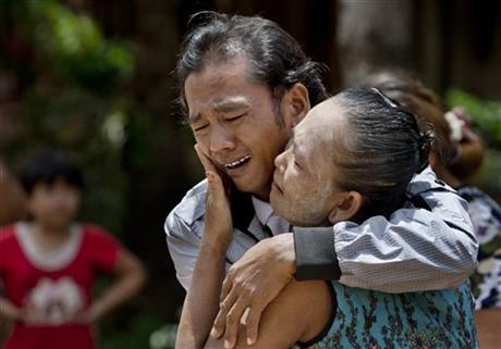 In this May 16, 2015, file photo, former slave fisherman Myint Naing and his mother, Khin Than, cry as they are reunited after 22 years at their village in Mon State, Myanmar. The Associated Press has won the Pulitzer Prize on Monday, April 18, 2016 for public service for articles documenting the use of slave labor in the commercial seafood industry in Indonesia and Thailand. (AP Photo/Gemunu Amarasinghe, File)