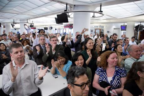 Associated Press employees applaud as the AP wins the Pulitzer Prize for public service, Monday, April 18, 2016, in New York. The AP report documented the use of slave labor in Southeast Asia to supply seafood to American tables, an investigation that spurred the release of more than 2,000 captive workers. (AP Photo/Mark Lennihan)
