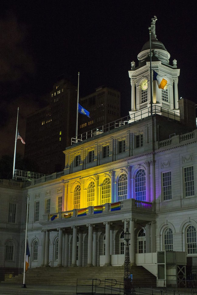 The New York City Hall building is illuminated in the colors of the LGBT pride flag in honor of the victims of the mass shooting in Orlando, Florida, in New York, Sunday, June 12, 2016. Credit - Andres Kudacki, AP