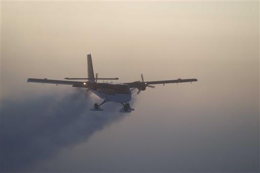In this 2003 photo, provided by the National Science Foundation, a Twin Otter flies out of the South Pole on a previous medical flight. A daring South Pole medical rescue is underway. An airplane left a British base in Antarctica Tuesday, June 21, 2016, for the 1,500-mile trip to evacuate a sick person from the U.S. station. Athena Dinar, spokeswoman for the British Antarctic Survey, said one of two twin otter planes began the trip Tuesday, while the other is still at the Rothera station on the Antarctic Peninsula just in case. (Jason Medley, National Science Foundation via AP)
