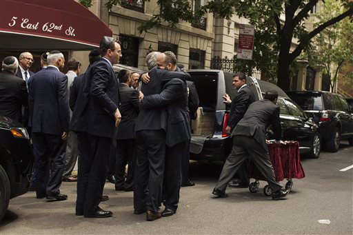 Family and friends embrace each other after they carried Elie Wiesel's coffin during a private service for the Nobel laureate and Holocaust survivor at the Fifth Avenue Synagogue in New York, Sunday, July 3, 2016. Wiesel shared the harrowing story of his internment at Auschwitz as a teenager through his classic memoir 
