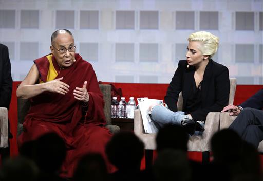 Lady Gaga listens as the Dalai Lama speaks during a question and answer session at the the U.S. Conference of Mayors in Indianapolis, Sunday, June 26, 2016. (AP Photo/Michael Conroy)