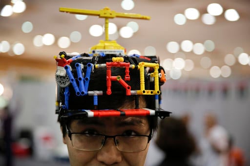 In this Sunday, Nov. 27, 2016 photo, a participant is seen at the World Robot Olympiad in New Delhi, India. The weekend games brought more than 450 teams of students from 50 countries to the Indian capital. The idea is to teach children computer programing at a young age. (AP Photo/Tsering Topgyal)