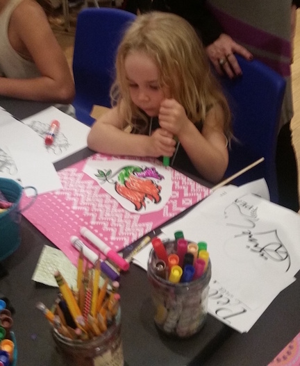Young girl hard at work on her peace flag at Laguna Art Museum