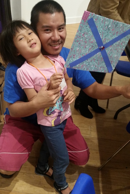 Father and daughter exhibit their finished flag at Art & Nature