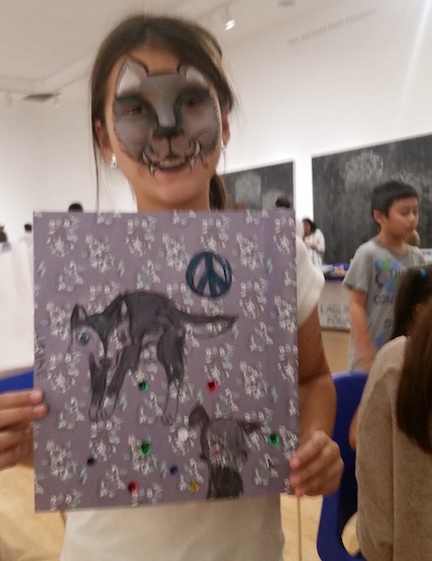Proud young artist and her beautifully drawn Peace Flag at LAM