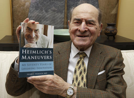 In this Feb. 5, 2014, file photo, Dr. Henry Heimlich holds his memoir prior to being interviewed at his home in Cincinnati. Heimlich, the surgeon who created the life-saving Heimlich maneuver for choking victims has died Saturday, Dec. 17, 2016, at Christ Hospital in Cincinnati. He was 96. (AP Photo/Al Behrman, File)