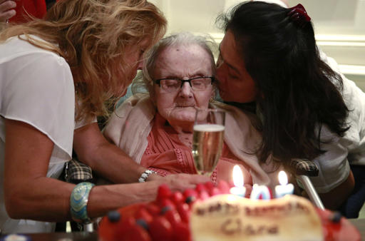 This is a Monday, Oct. 10, 2016 file photo of Clare Hollingworth, center, a British former longtime foreign correspondent, is surrounded by friends and admirers at her birthday party at Hong Kong's Foreign Correspondents' Club. British war correspondent Clare Hollingworth, who broke the news of the Nazi invasion of Poland that started World War II, has died in Hong Kong Tuesday Jan. 10, 2017, at the age of 105. She spent her life on the front lines of the world's major conflicts, reporting from the Middle East, North Africa and Vietnam, for British newspapers, then lived her final decades in Hong Kong after being stationed in China in the 1970s.? (AP Photo/Kin Cheung, File)