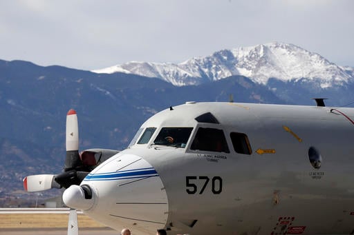 This Feb. 17, 2017, photo shows a Navy P-3 Orion aircraft used for a NASA-led experiment called SnowEx, on an airfield at Peterson Air Force Base in Colorado Springs, Colo. Instrument-laden aircraft are surveying the Colorado high country this month as scientists search for better ways to measure how much water is locked up in the world's mountain snows - water that sustains a substantial share of the global population. (AP Photo/Brennan Linsley)