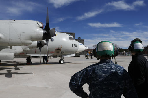 In this Feb. 17, 2017 photo, military ground crew attend to a Navy P-3 Orion aircraft used for a NASA-led experiment called SnowEx, on an airfield at Peterson Air Force Base in Colorado Springs, Colo. Airplanes are scanning the Colorado high country with an array of sensors as scientists search for better ways to measure how much water is locked up in the world's mountain snows. (AP Photo/Brennan Linsley)