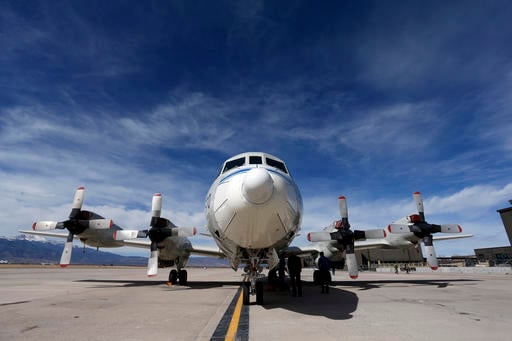 This Feb. 17, 2017, photo shows a Navy P-3 Orion aircraft used for a NASA-led experiment called SnowEx, on an airfield at Peterson Air Force Base in Colorado Springs, Colo. Instrument-laden aircraft are surveying the Colorado high country this month as scientists search for better ways to measure how much water is locked up in the world's mountain snows - water that sustains a substantial share of the global population. (AP Photo/Brennan Linsley)