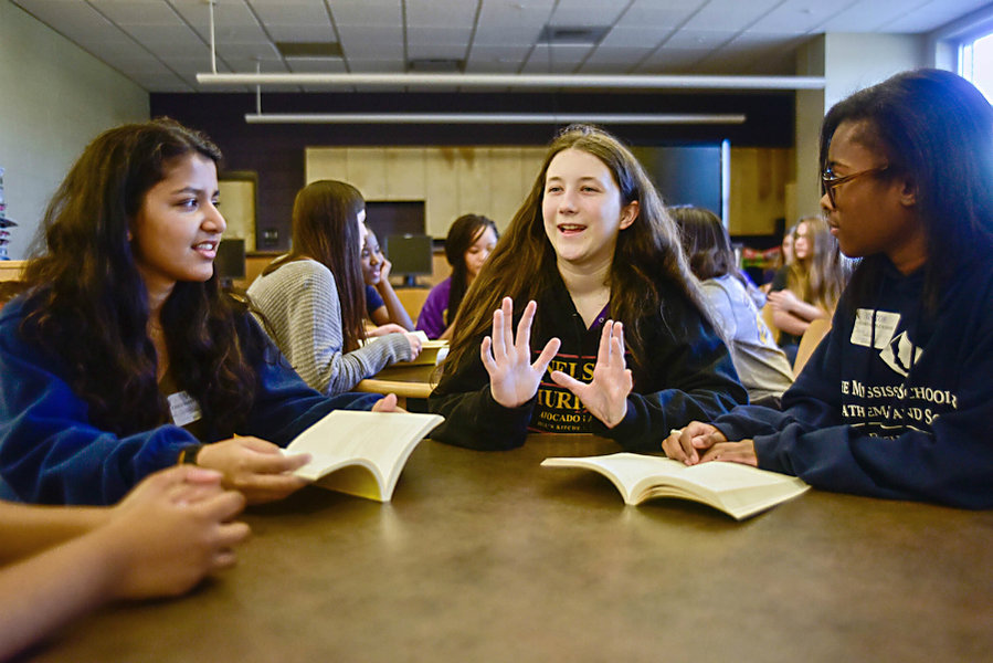 Mississippi School for Mathematics and Science students Wrishija Roy (l.) and Damare Baker (r.), both 17, listen to Columbus Middle School student Henrietta Krogh, 13, during a book club meeting Feb. 9 in the middle school’s library in Columbus, Miss. (Luisa Porter/The Commercial Dispatch/AP)