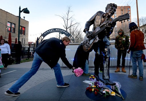 David Gaule, from Springfield, Ill. drops off flowers at the statue of music legend Chuck Berry on the Delmar Loop, in University City on Saturday, March 18, 2017. Berry died earlier today at the age of 90. After hearing Berry died Gaule drove to St. Louis from Springfield to pay his respects. (David Carson/St. Louis Post-Dispatch via AP)