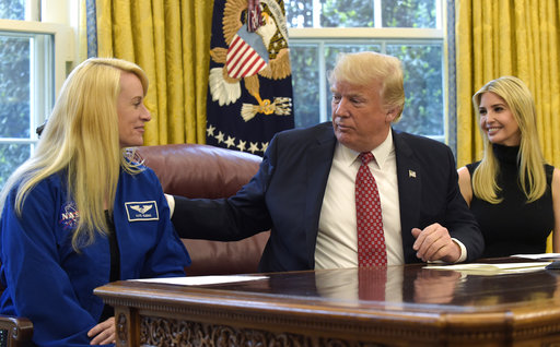 President Donald Trump, accompanied by his daughter Ivanka Trump, talks with NASA astronaut Kate Rubins, following a video conference with the International Space Station, Monday, April 24, 2017, from the Oval Office of the White House in Washington. (AP Photo/Susan Walsh)