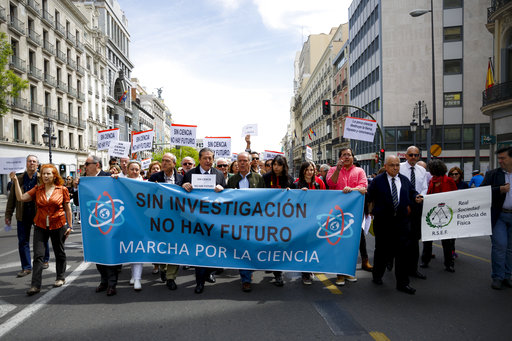 People march holding a banner that reads 'there is no future without investigation'' at the March for Science event in Madrid, Saturday, April 22, 2017. Thousands of scientists worldwide left their labs to take to the streets Saturday along with students and research advocates in pushing back against what they say are mounting attacks on science. (AP Photo/Daniel Ochoa de Olza)